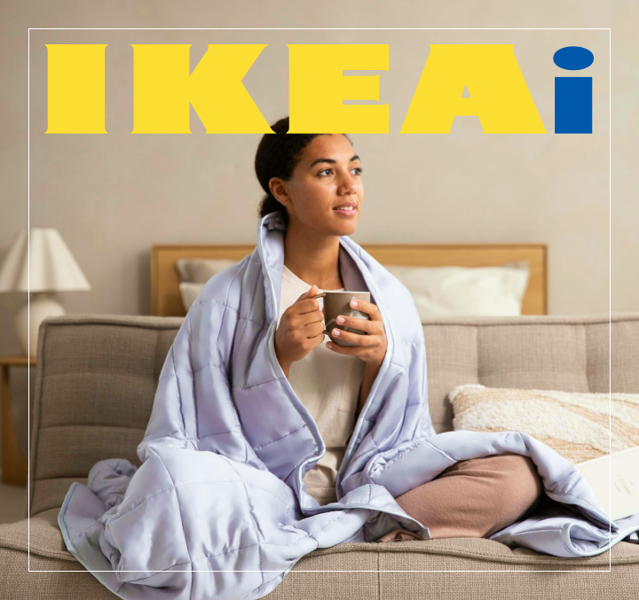 Person relaxing in a cozy bedroom with IKEA furniture, holding a coffee mug